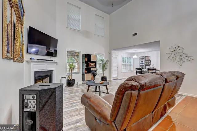 a living room with furniture a flat screen tv and a fireplace