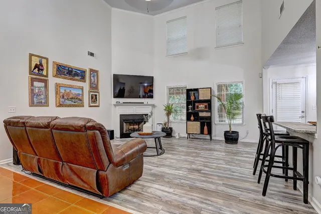 a living room with furniture fireplace and wooden floor