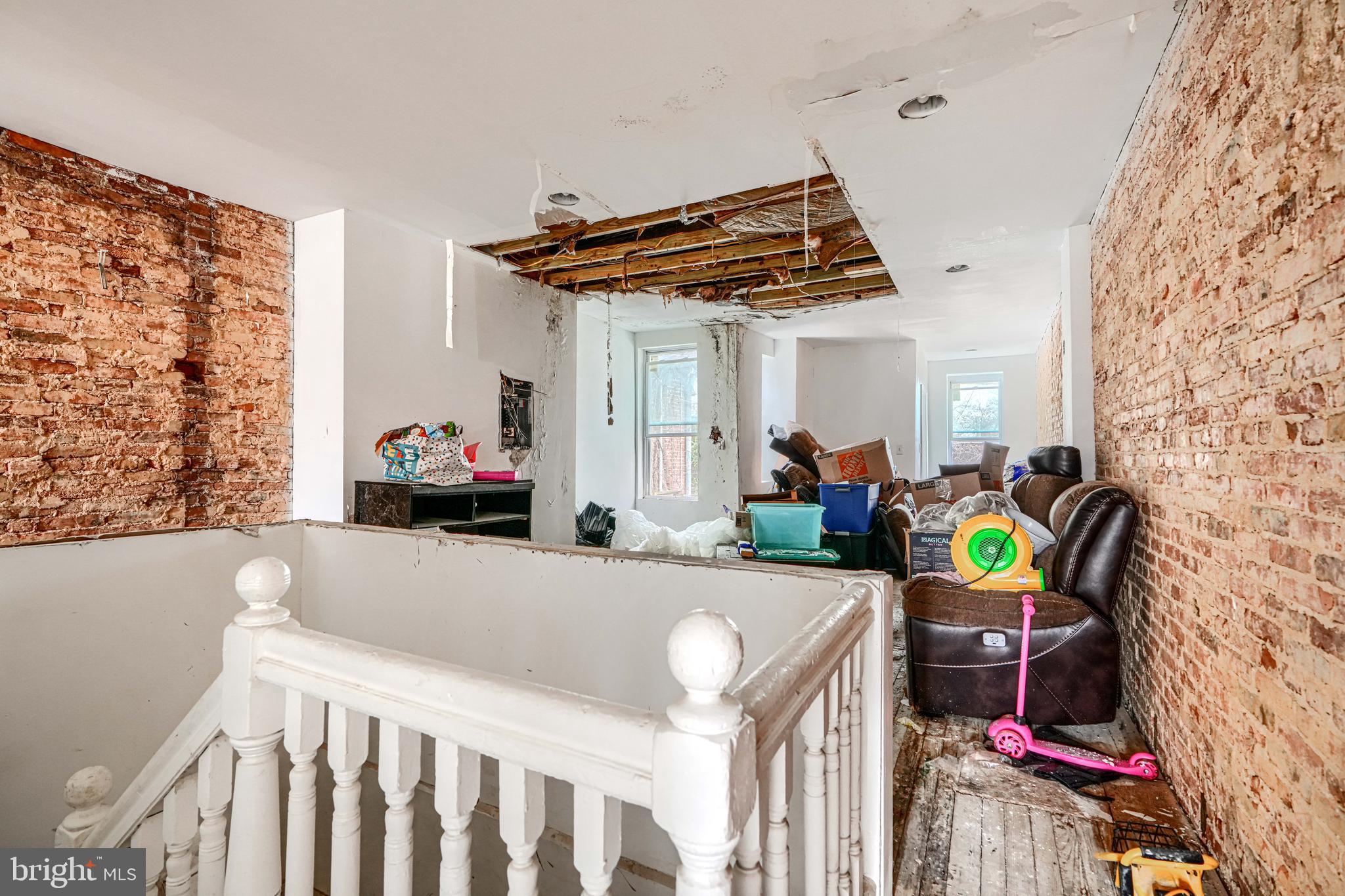 1312 Aisquith Street Baltimore, MD 21202 - Photo 14 of 25 a living room with furniture and a chair