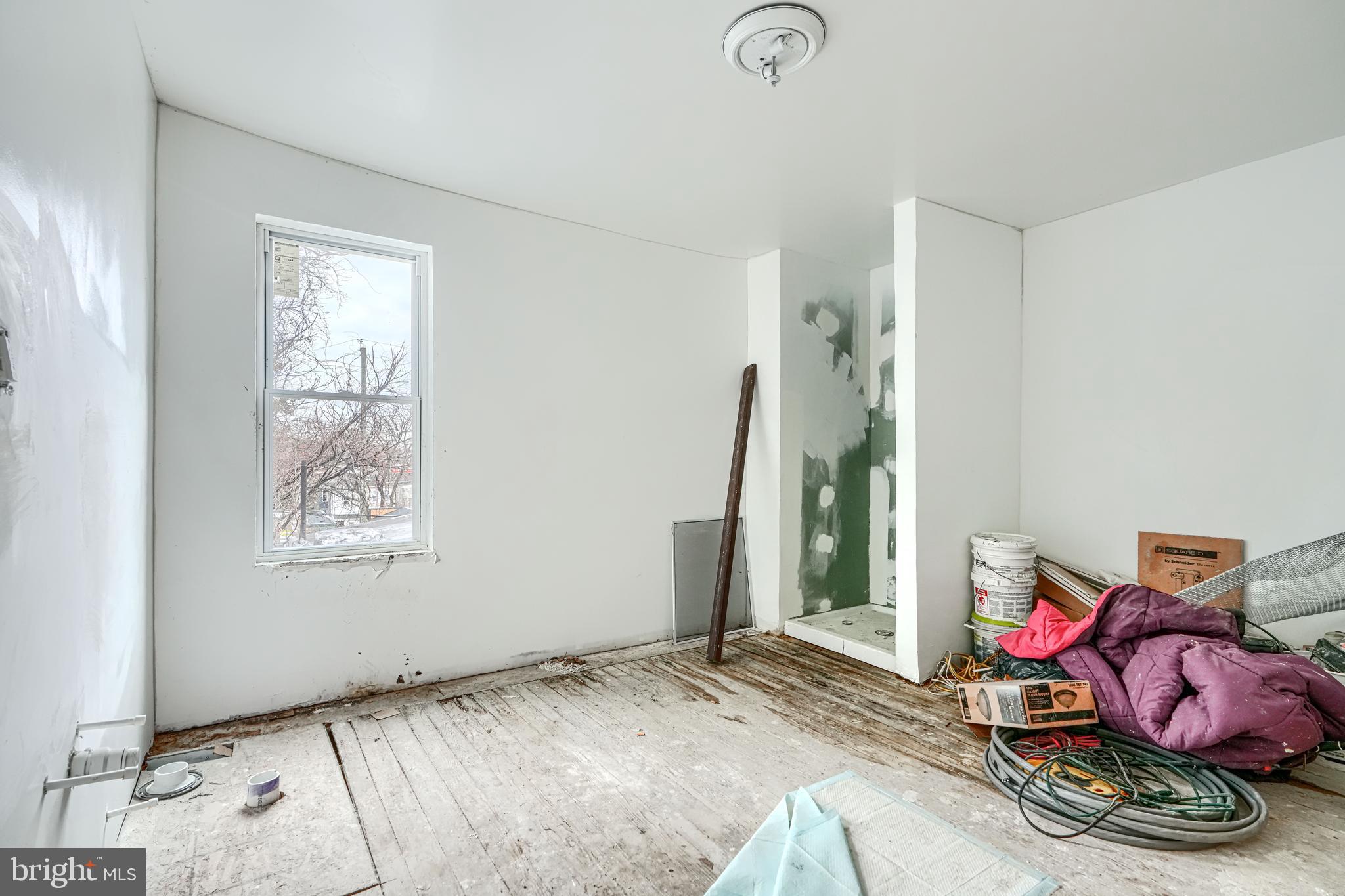 1312 Aisquith Street Baltimore, MD 21202 - Photo 17 of 25 a bedroom with a bed and a window