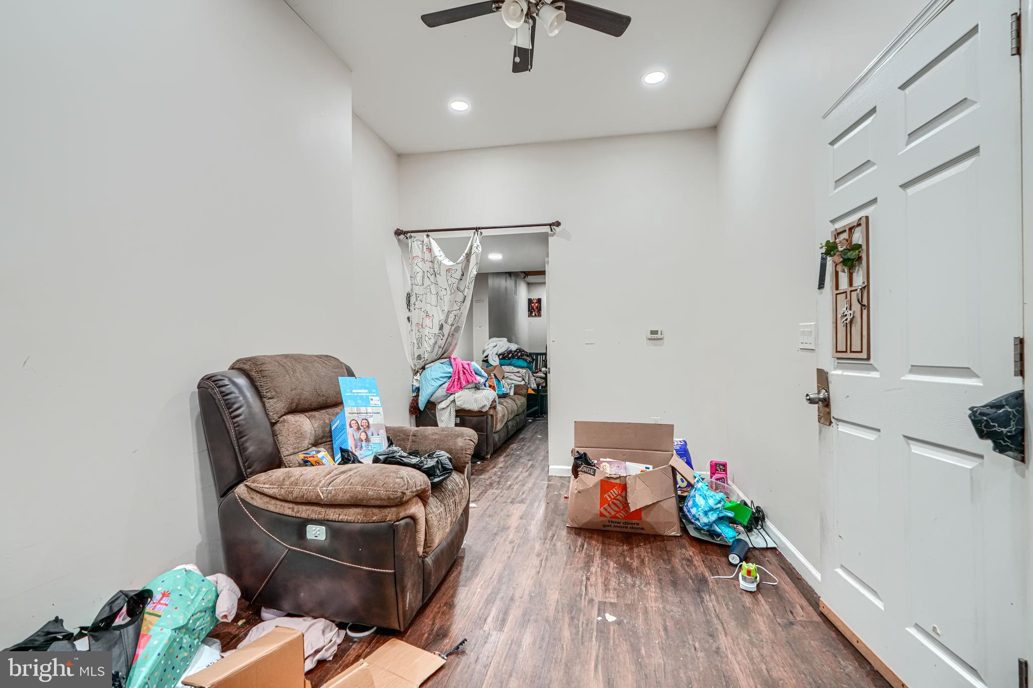 1312 Aisquith Street Baltimore, MD 21202 - Photo 4 of 25 a living room with furniture and wooden floor
