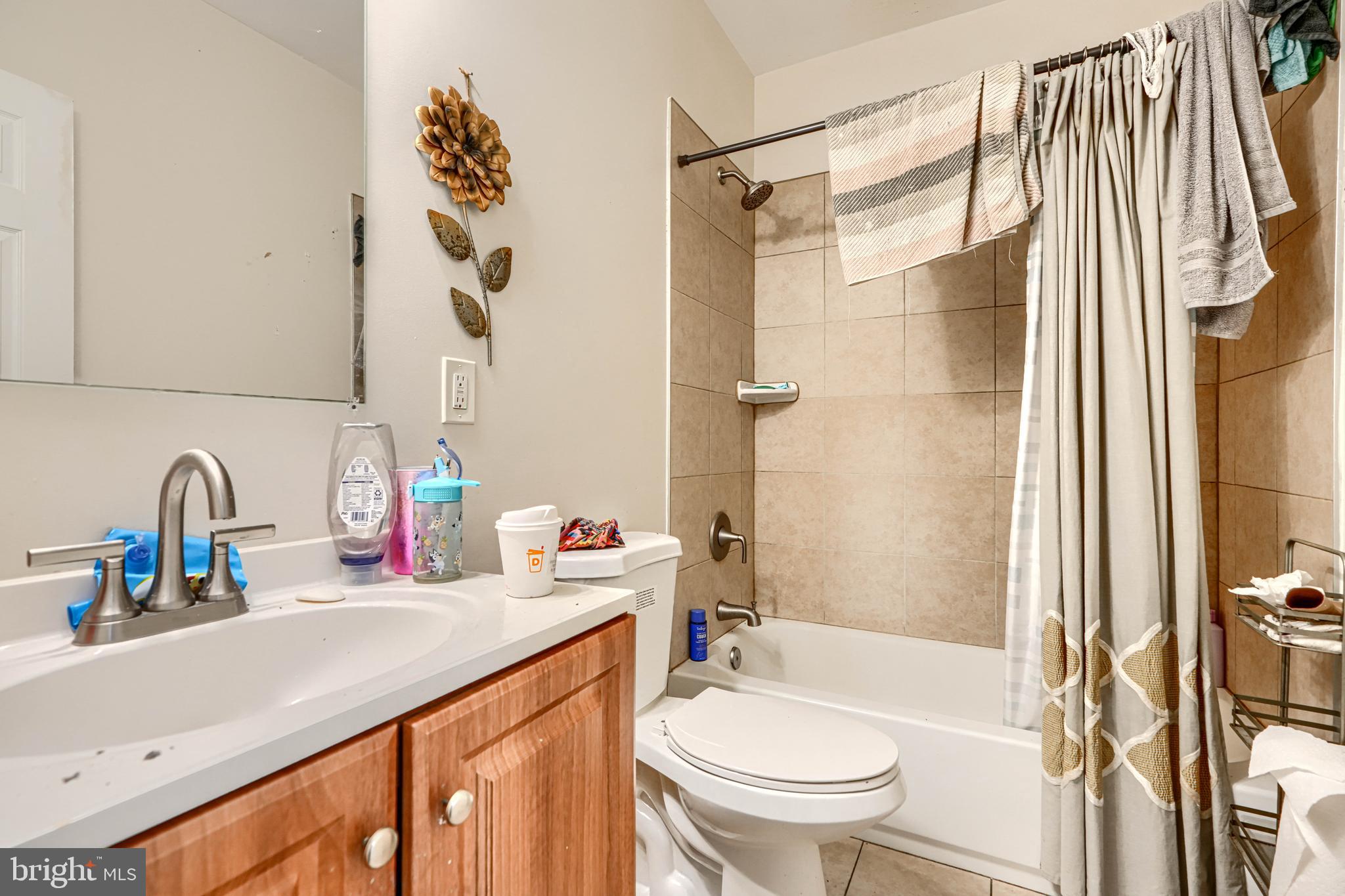 1312 Aisquith Street Baltimore, MD 21202 - Photo 10 of 25 a bathroom with a sink toilet and shower