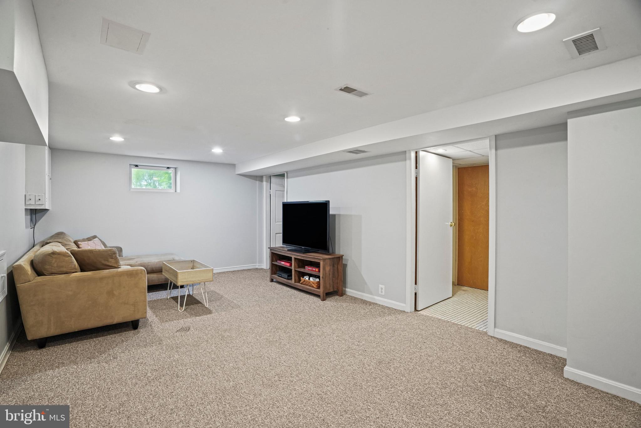 1907 Brisbane Street Silver Spring, MD 20902 - Photo 33 of 39 a living room with furniture and a flat screen tv