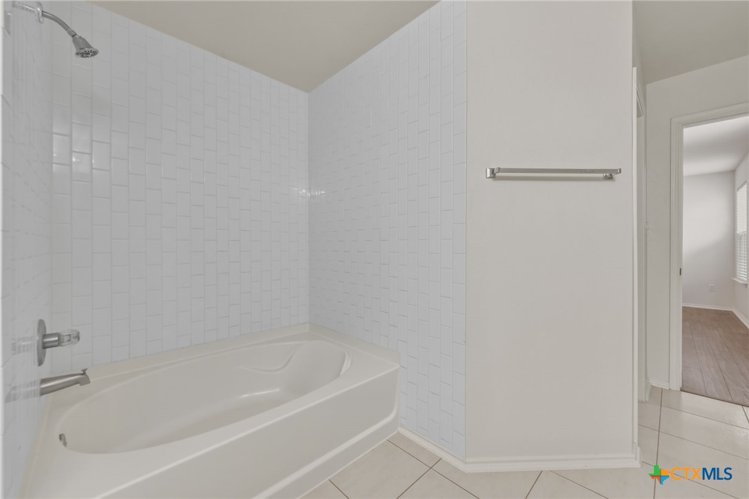 109 Comal Cove Elgin, TX 78621 - Photo 29 of 34 a white bath tub and shower