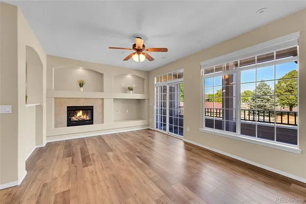 a view of an empty room with a fireplace and a window