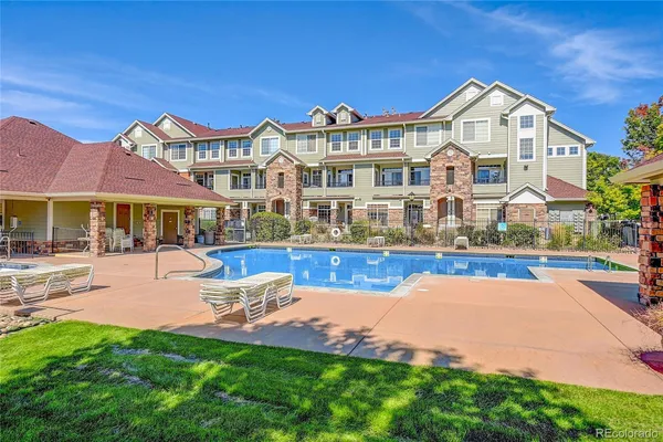 a front view of a house with swimming pool and porch