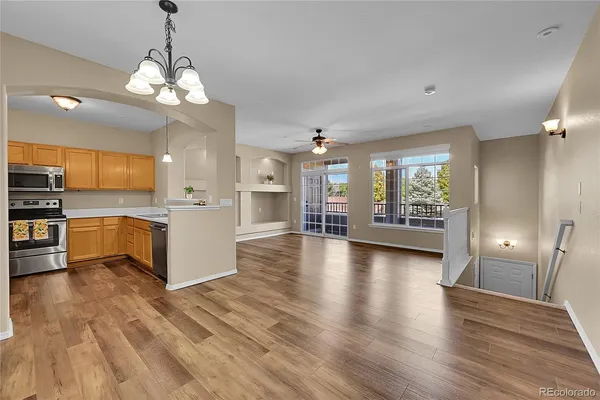 a view of a kitchen with a sink and dishwasher a refrigerator with wooden floor