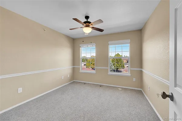 a view of room with window and ceiling fan