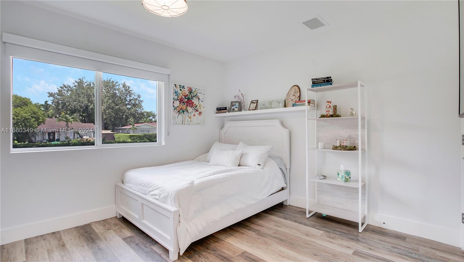 3601 Southwest 58th Avenue Miami, FL 33155 - Photo 14 of 19 a white bed sitting in a bedroom next to a window