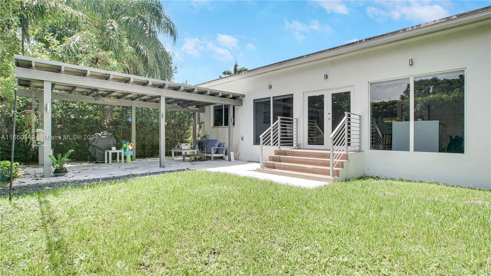 3601 Southwest 58th Avenue Miami, FL 33155 - Photo 18 of 19 a view of a patio with table and chairs potted plants and large tree