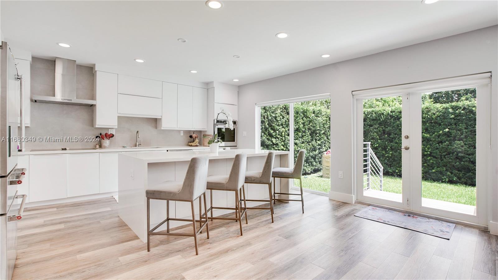 3601 Southwest 58th Avenue Miami, FL 33155 - Photo 6 of 19 a kitchen with a table chairs wooden cabinets and wooden floor