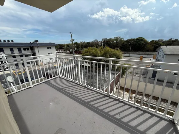 a view of balcony with wooden floor and city view