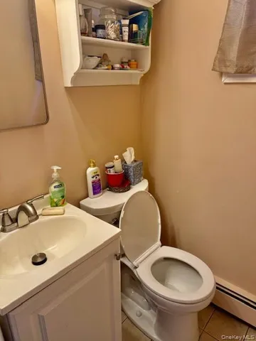 a bathroom with a sink mirror and toilet
