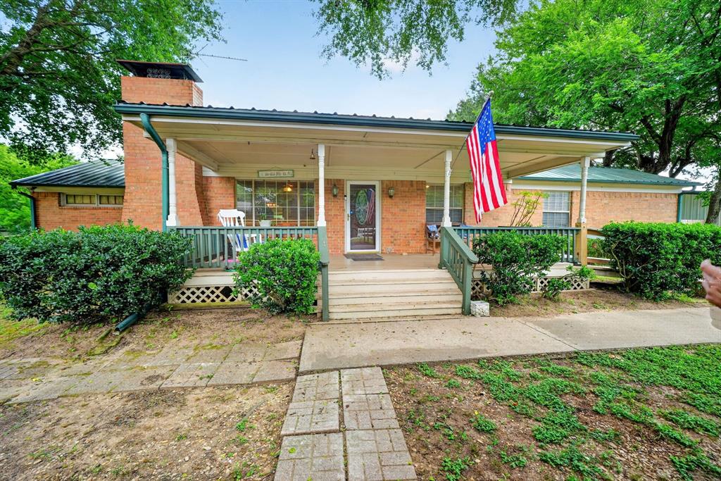 111 County Road 2806 Mabank, TX 75147 - Photo 7 of 34 Brick exterior with green trim and a covered front porch