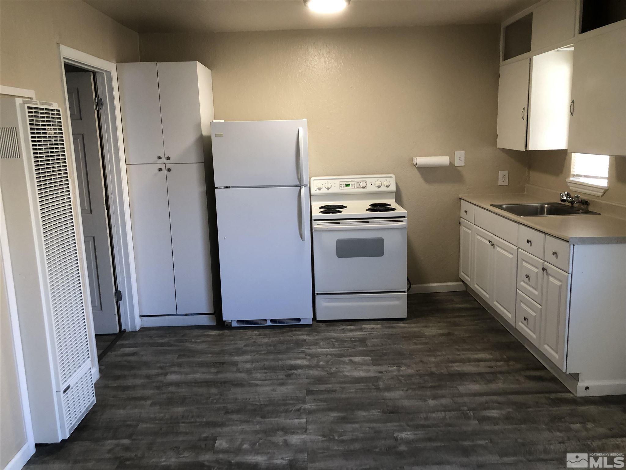 770 Montello Street Reno, NV 89512 - Photo 2 of 10 a kitchen with granite countertop a refrigerator a sink and a stove