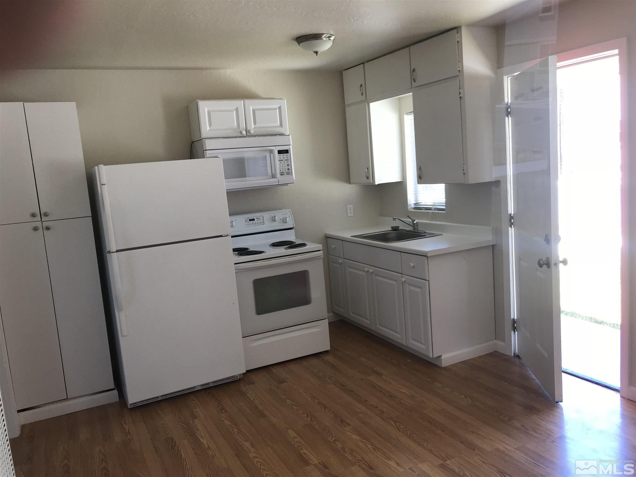770 Montello Street Reno, NV 89512 - Photo 5 of 10 a kitchen with a stove a refrigerator and a sink
