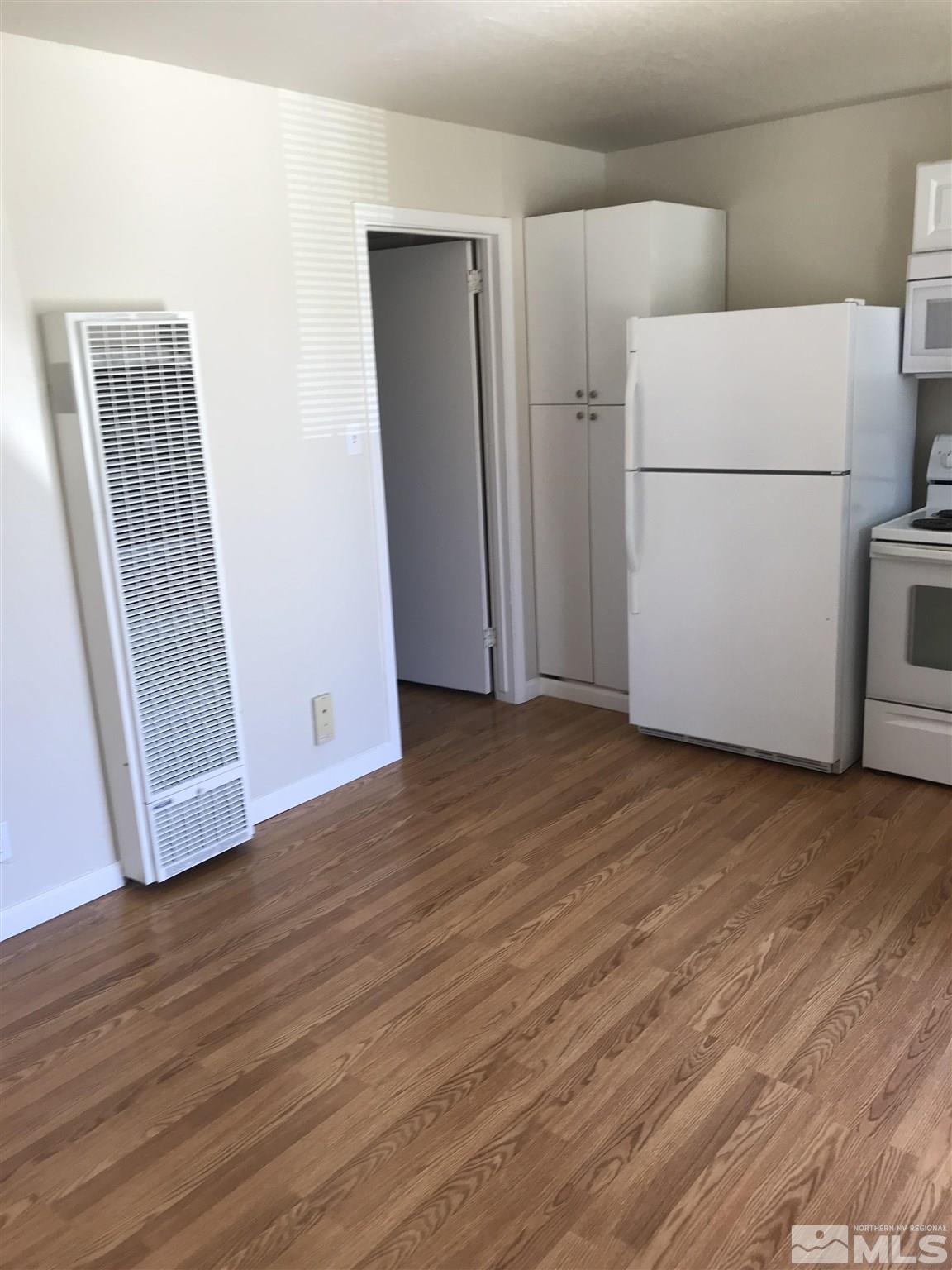 770 Montello Street Reno, NV 89512 - Photo 6 of 10 a view of a kitchen with wooden floor and refrigerator