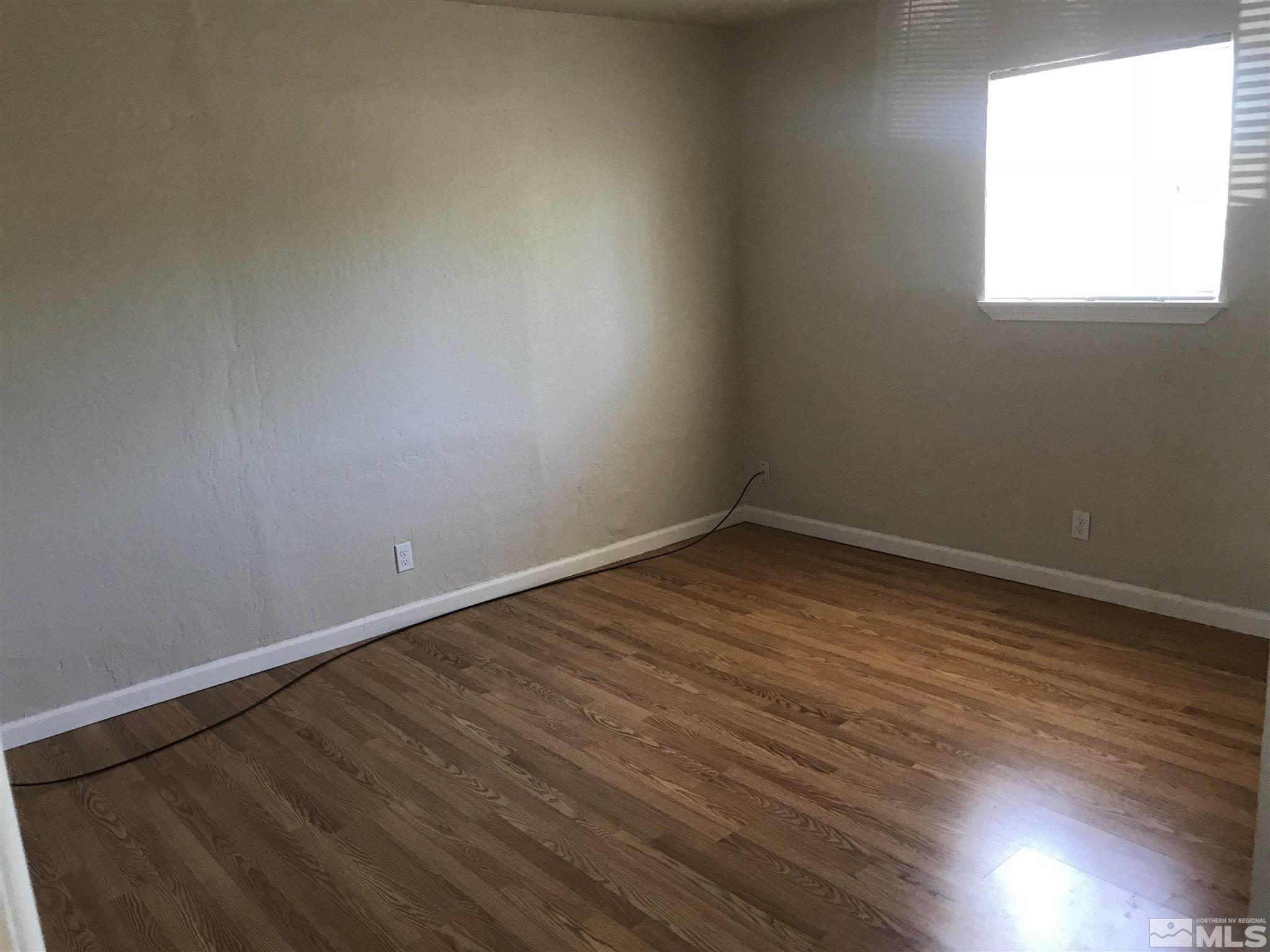770 Montello Street Reno, NV 89512 - Photo 7 of 10 an empty room with wooden floor and windows