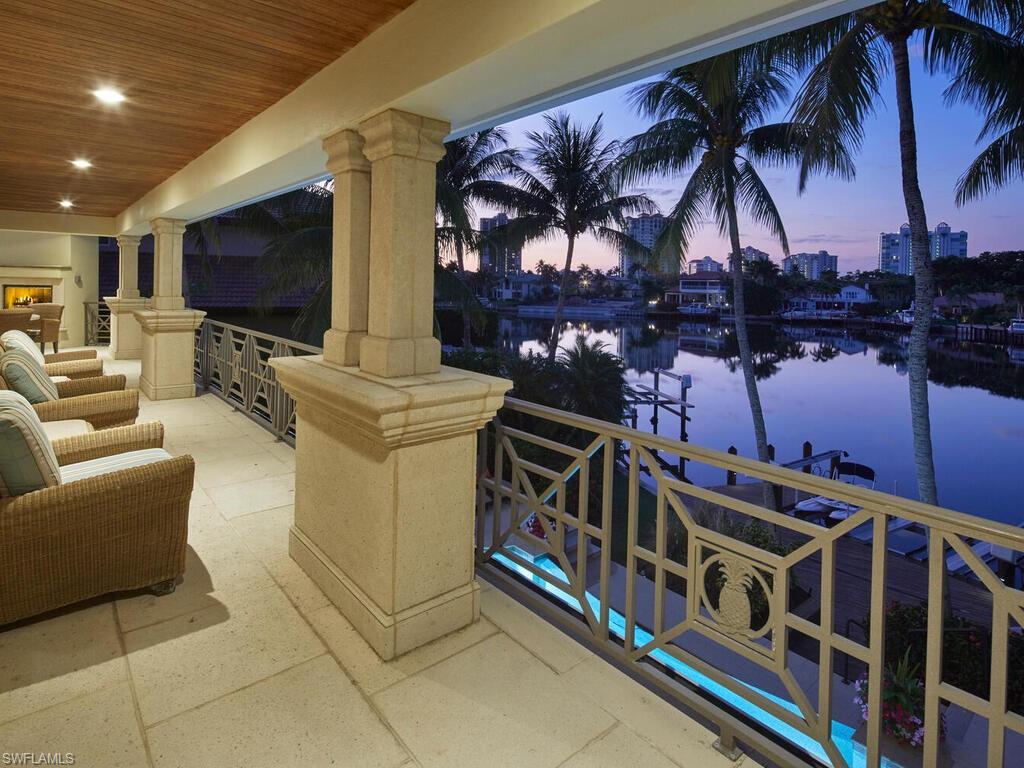 377 Pirates Bight Naples, FL 34103 - Photo 6 of 44 a living room with furniture and a flat screen tv