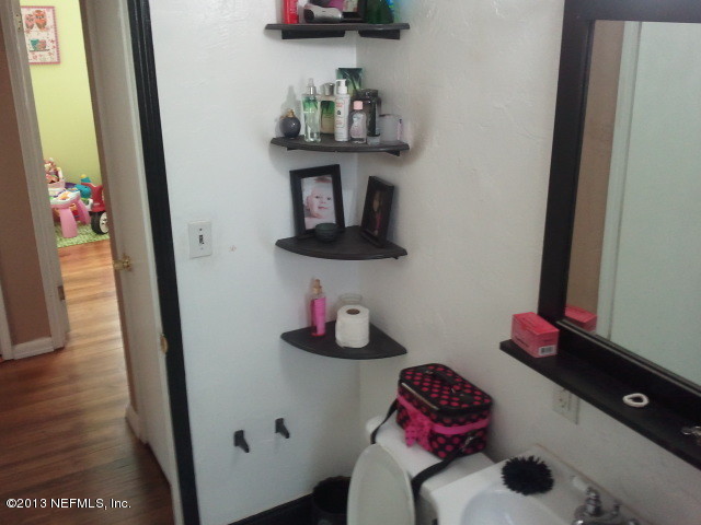 2133 Newberry Road Jacksonville, FL 32218 - Photo 13 of 29 a bathroom with a sink and a mirror
