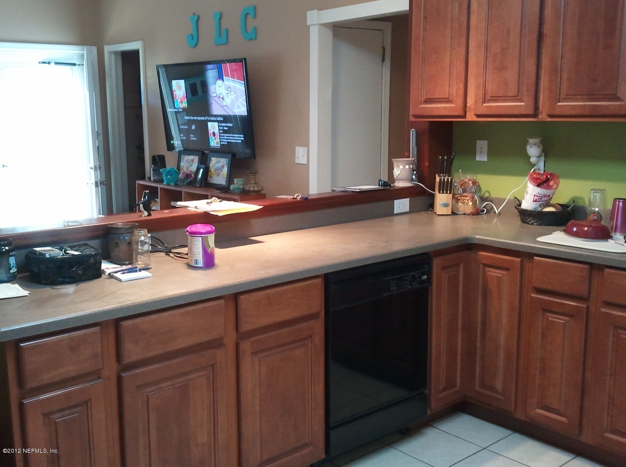 2133 Newberry Road Jacksonville, FL 32218 - Photo 22 of 29 a kitchen with stainless steel appliances granite countertop a sink dishwasher stove and cabinets