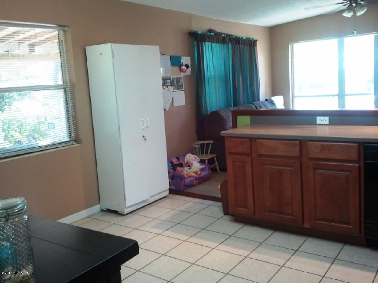 2133 Newberry Road Jacksonville, FL 32218 - Photo 23 of 29 a kitchen with a refrigerator and window