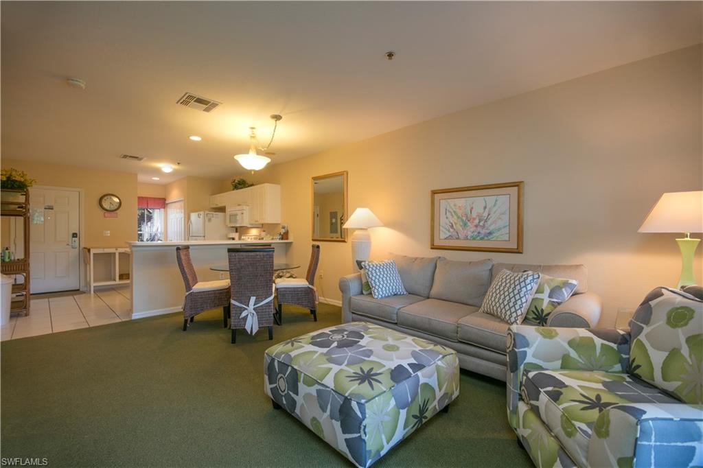 7870 Mahogany Run Lane, Unit 1713 Naples, FL 34113 - Photo 1 of 15 a living room with furniture and a table