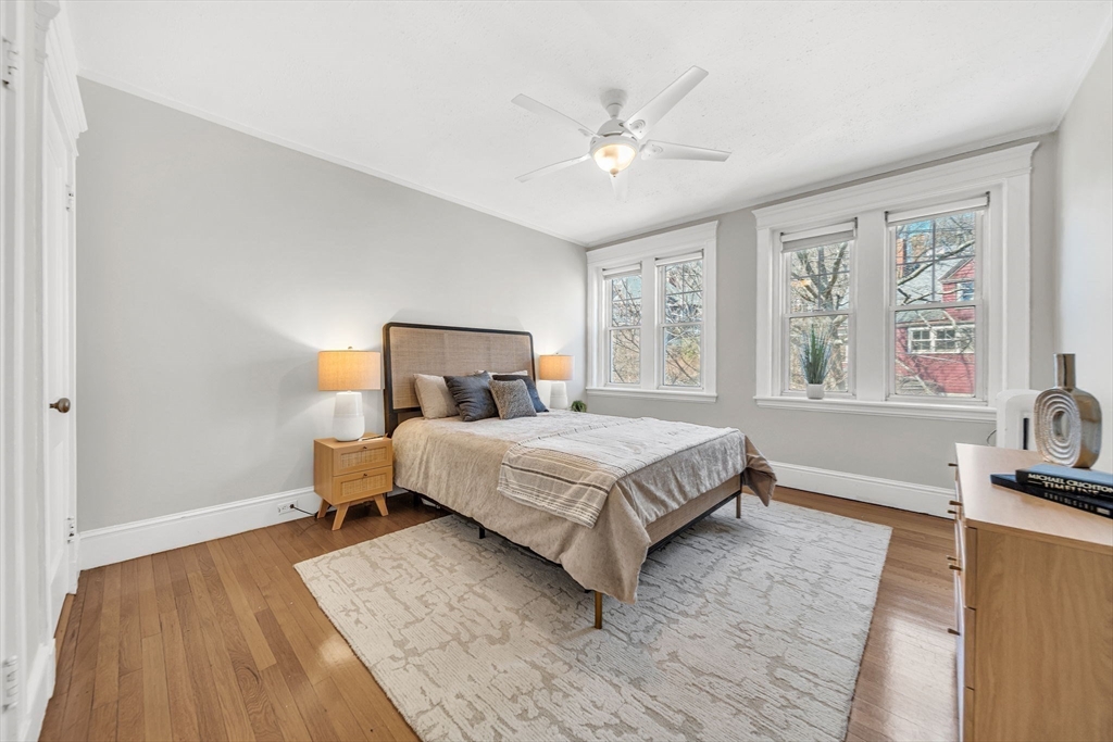 50 Lancaster Terrace, Unit 4 Brookline, MA 02446 - Photo 11 of 20 a bedroom with a large bed and a chandelier