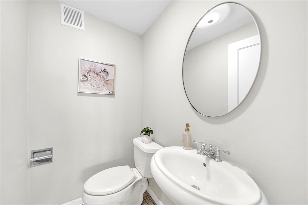 50 Lancaster Terrace, Unit 4 Brookline, MA 02446 - Photo 14 of 20 a bathroom with a toilet a sink and a mirror