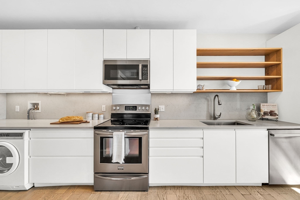 50 Lancaster Terrace, Unit 4 Brookline, MA 02446 - Photo 7 of 20 a kitchen with granite countertop white cabinets and white appliances