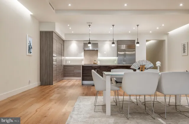 a large kitchen with a table and chairs