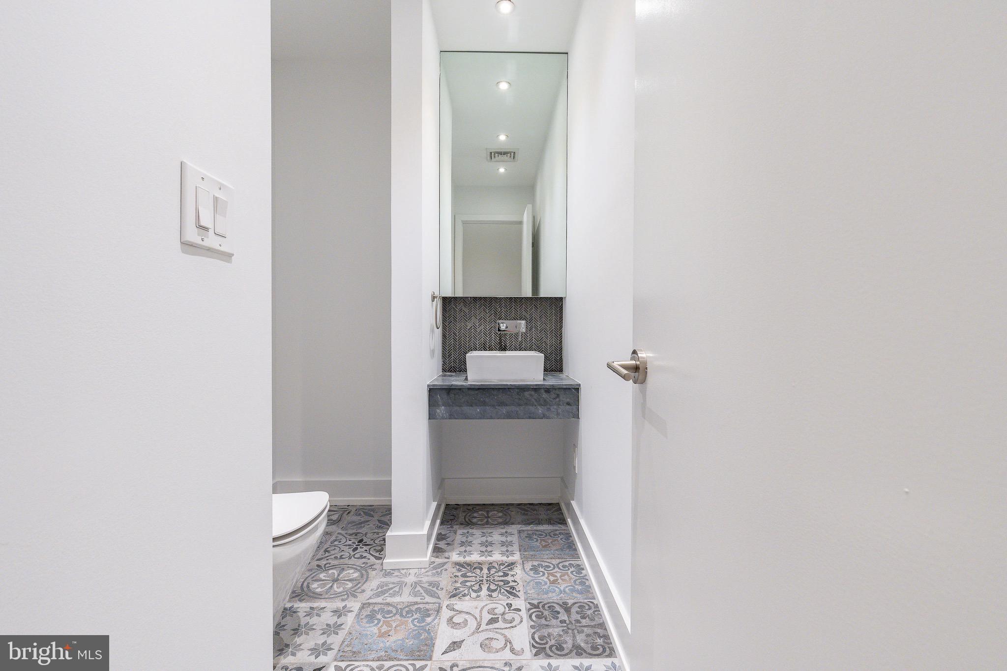 725 Chestnut Street, Unit 2 Philadelphia, PA 19106 - Photo 15 of 29 a bathroom with a granite countertop sink toilet and shower