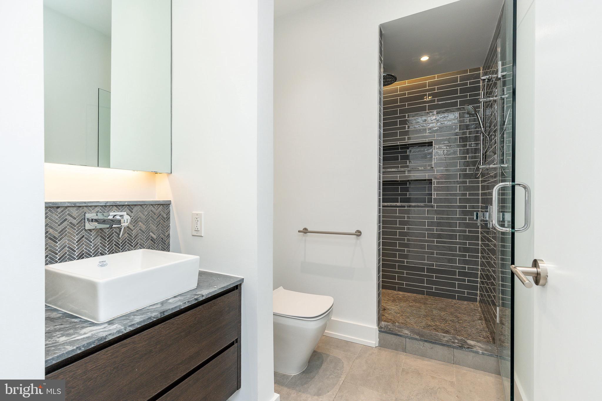725 Chestnut Street, Unit 2 Philadelphia, PA 19106 - Photo 24 of 29 a bathroom with a granite countertop sink a toilet and shower