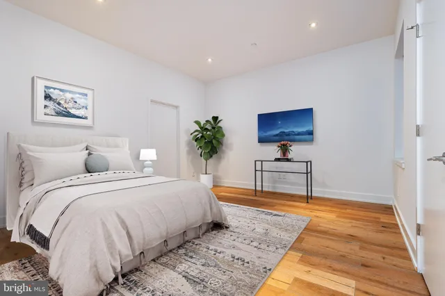 a bathroom with a granite countertop sink a toilet and shower