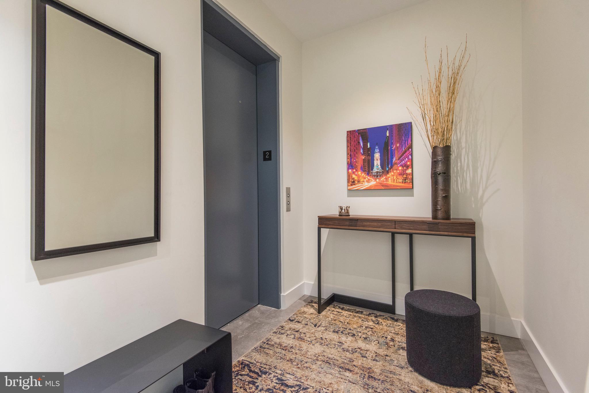 725 Chestnut Street, Unit 2 Philadelphia, PA 19106 - Photo 4 of 29 a hallway with a desk and chair with wooden floor