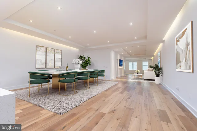 a living room with furniture a rug and a table