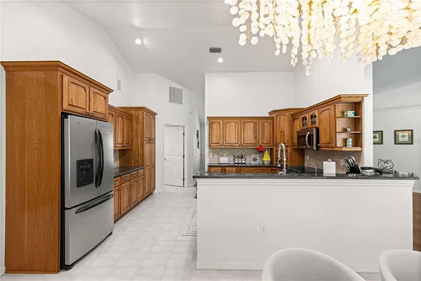 a kitchen with stainless steel appliances a refrigerator and a sink