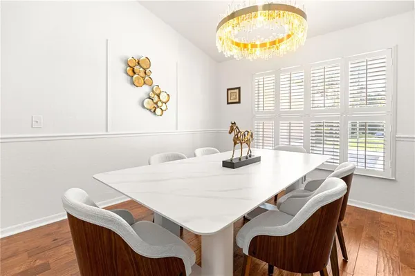 a view of a dining room with furniture and a window