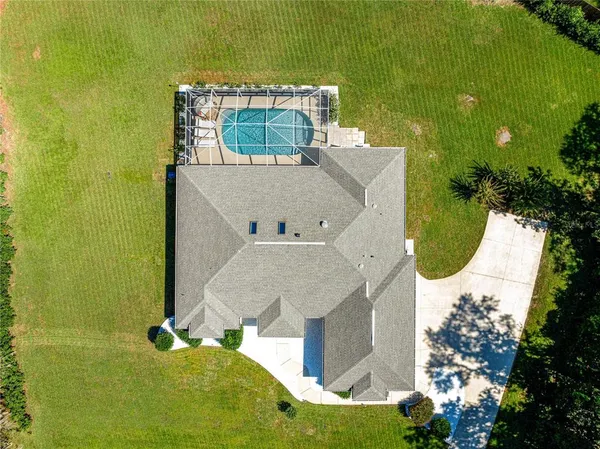 an aerial view of a house with a swimming pool