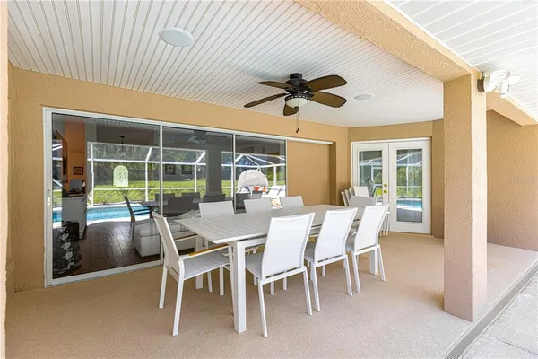 a dining room with furniture a rug and a large window