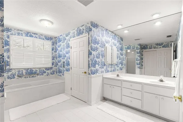 a bathroom with a bathtub and shower