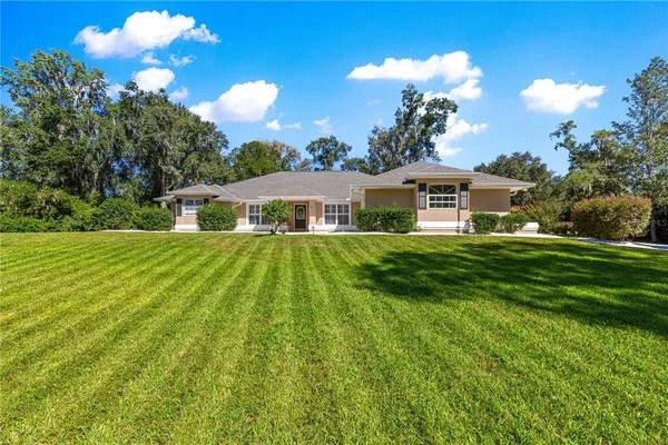 a house view with swimming pool and garden space