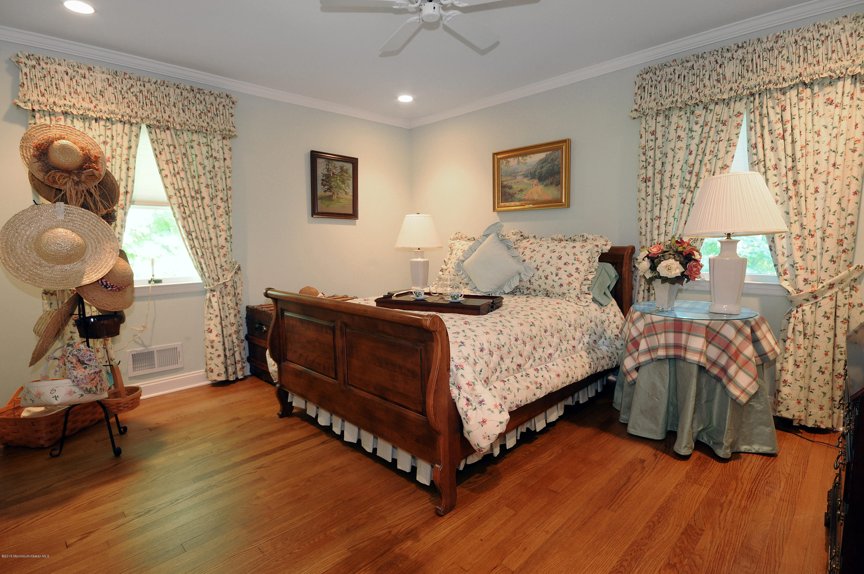 57 Heyers Mill Road Colts Neck, NJ 07722 - Photo 24 of 35 a bedroom with a bed and a chandelier