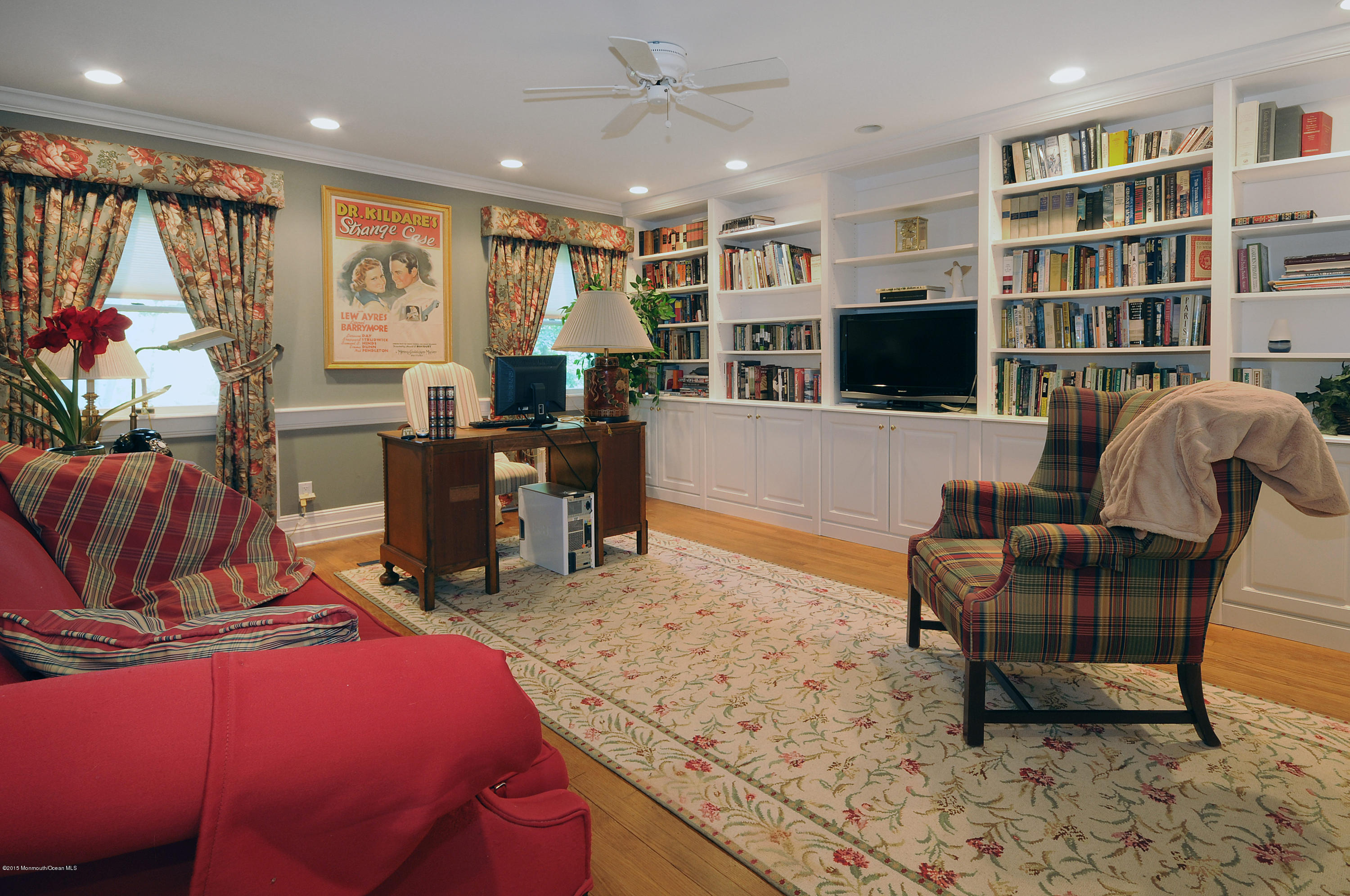 57 Heyers Mill Road Colts Neck, NJ 07722 - Photo 25 of 35 a living room with furniture a flat screen tv and floor to ceiling window