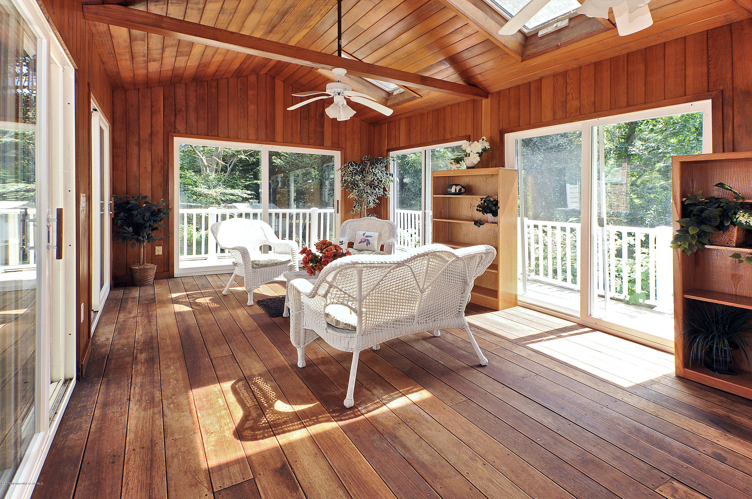 57 Heyers Mill Road Colts Neck, NJ 07722 - Photo 28 of 35 a dining room with wooden floor a glass table and chairs