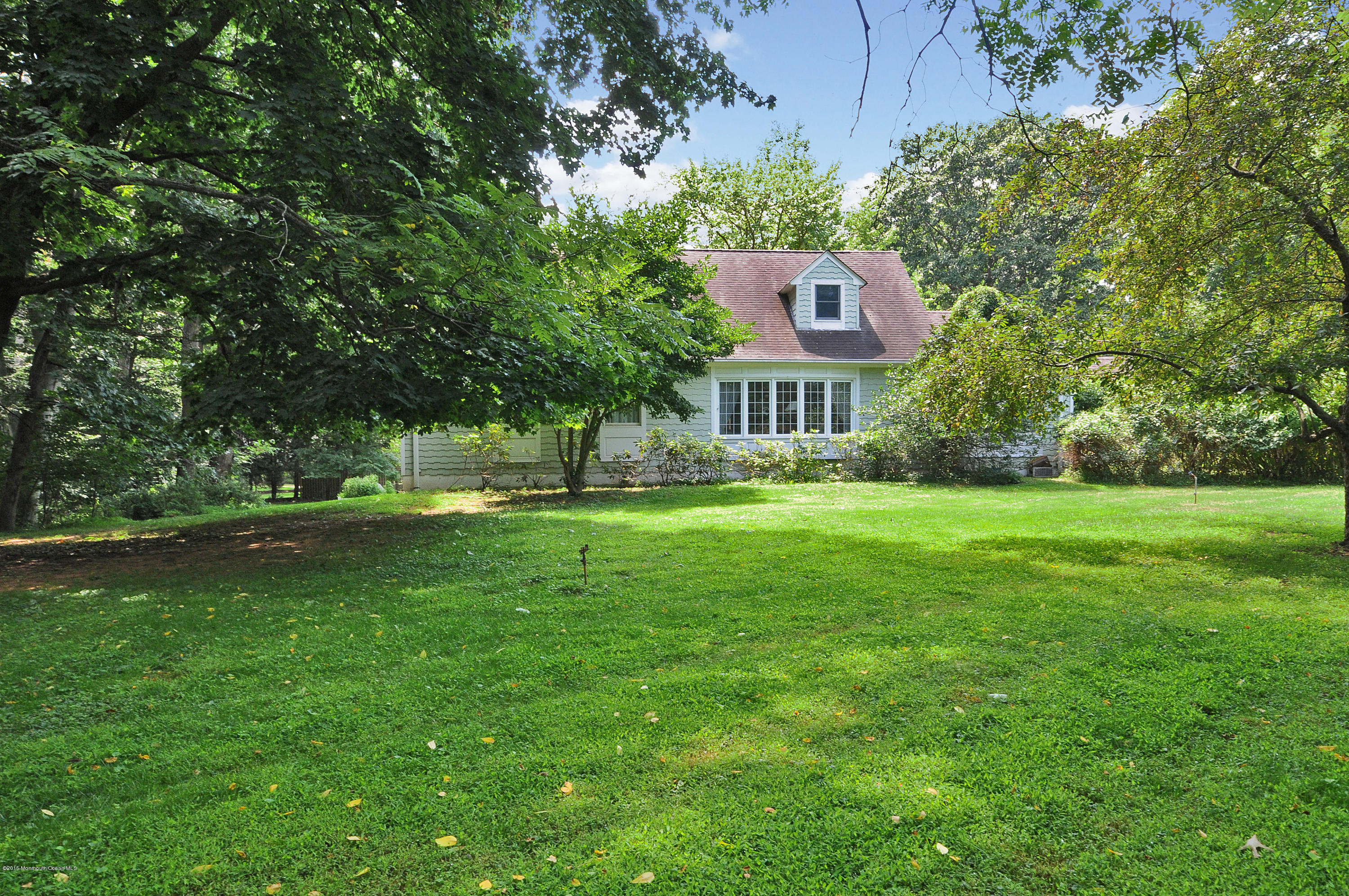 57 Heyers Mill Road Colts Neck, NJ 07722 - Photo 3 of 35 a house view with a garden space