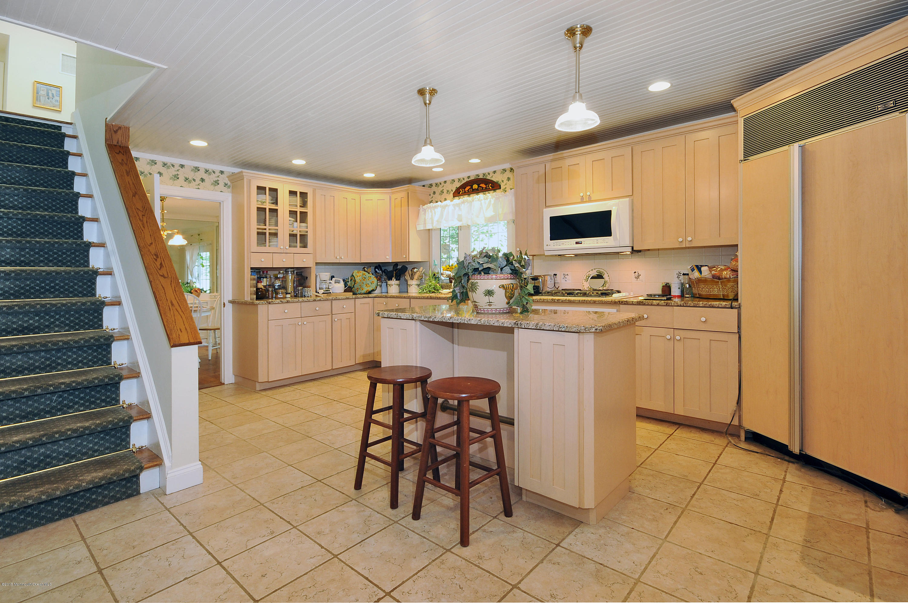57 Heyers Mill Road Colts Neck, NJ 07722 - Photo 31 of 35 a kitchen with sink cabinets and dining room