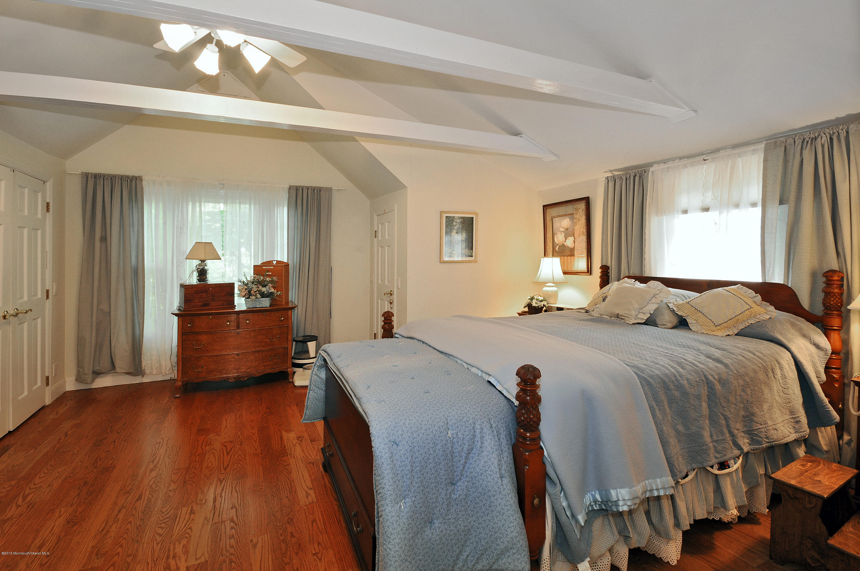 57 Heyers Mill Road Colts Neck, NJ 07722 - Photo 10 of 35 a bedroom with a bed and wooden floor