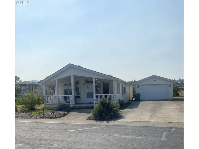 a front view of a house with a garden and pathway