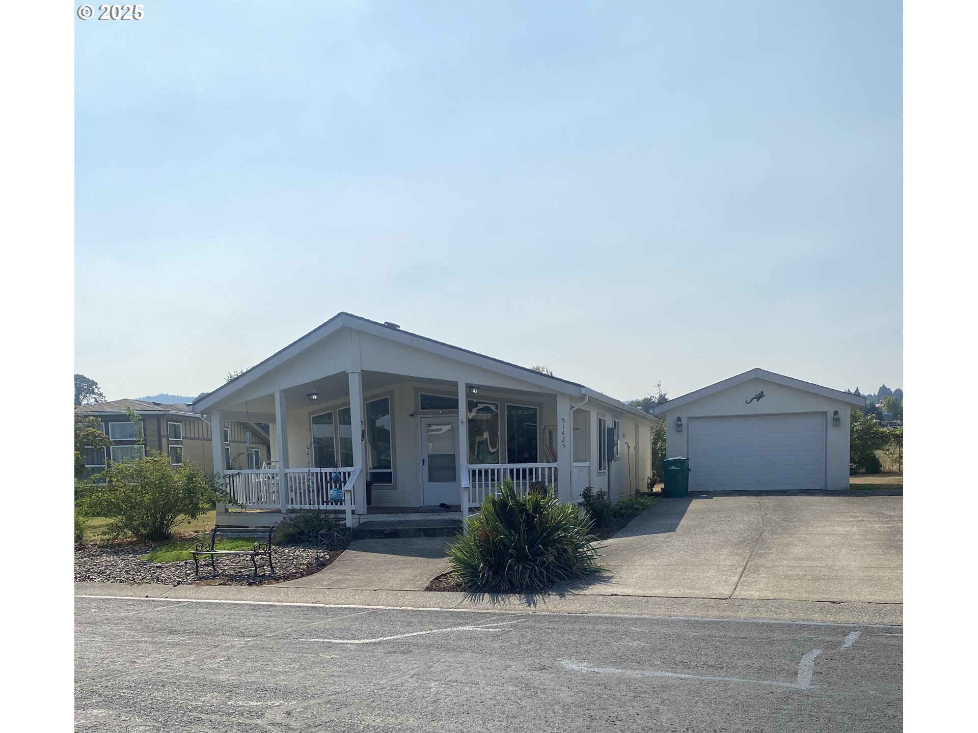 a front view of a house with a garden and pathway